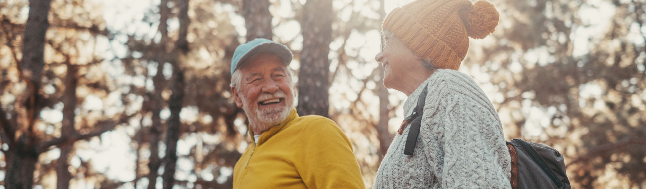 Portrait close up head shot of one cheerful smiling middle age woman walking with her husband enjoying free time and nature. Active beautiful seniors in love together at sunny day.